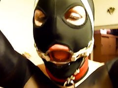 Putting giant penis gag in slave's slut ring gagged mouth